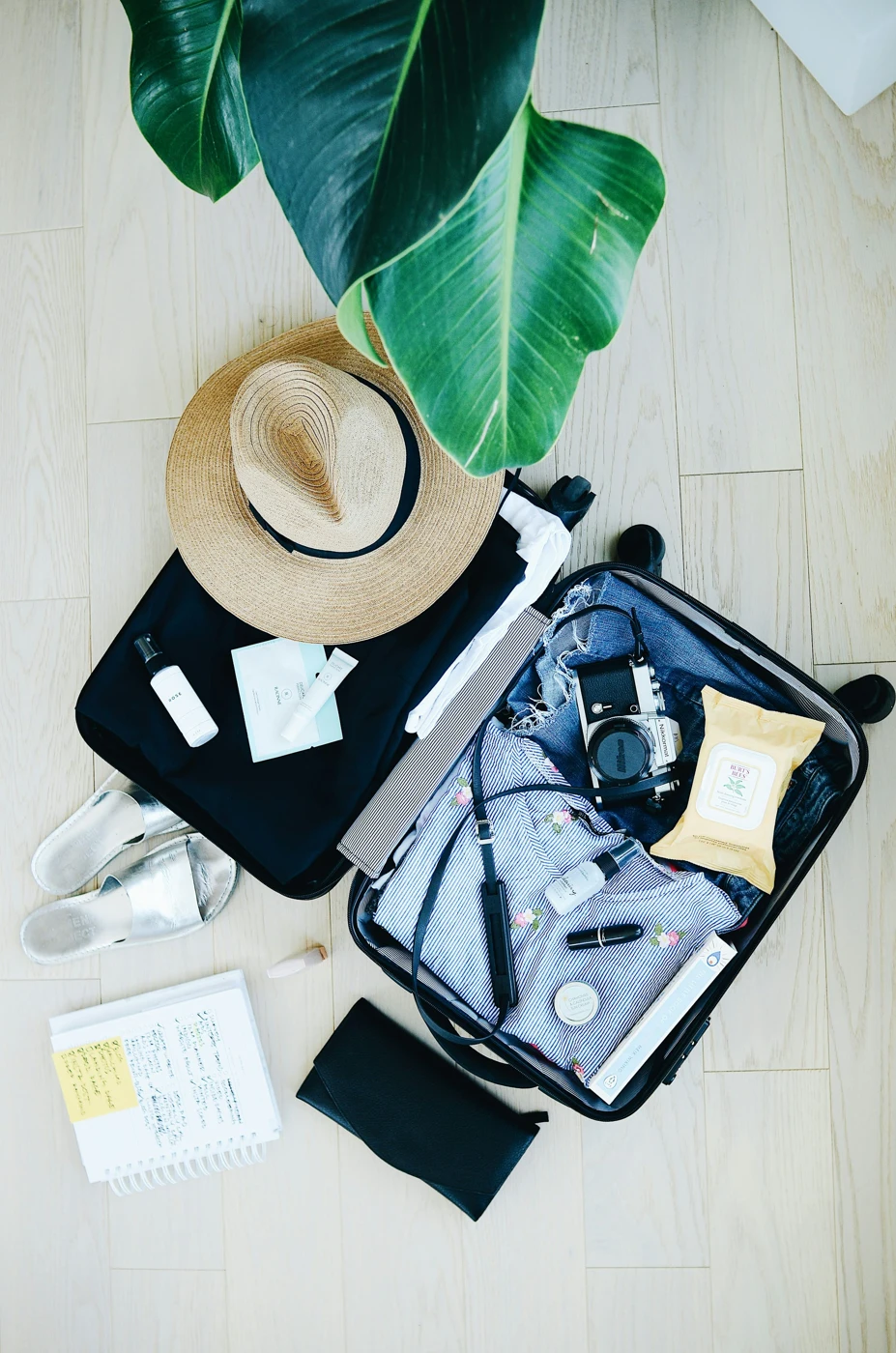 Travel packing essentials and a sun hat