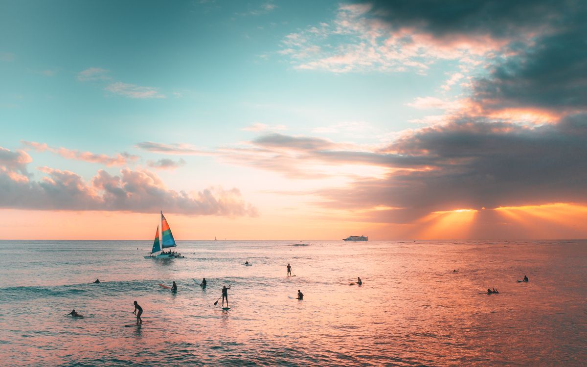 Representative Hawaiian sunset sailing scene, not the exact tour